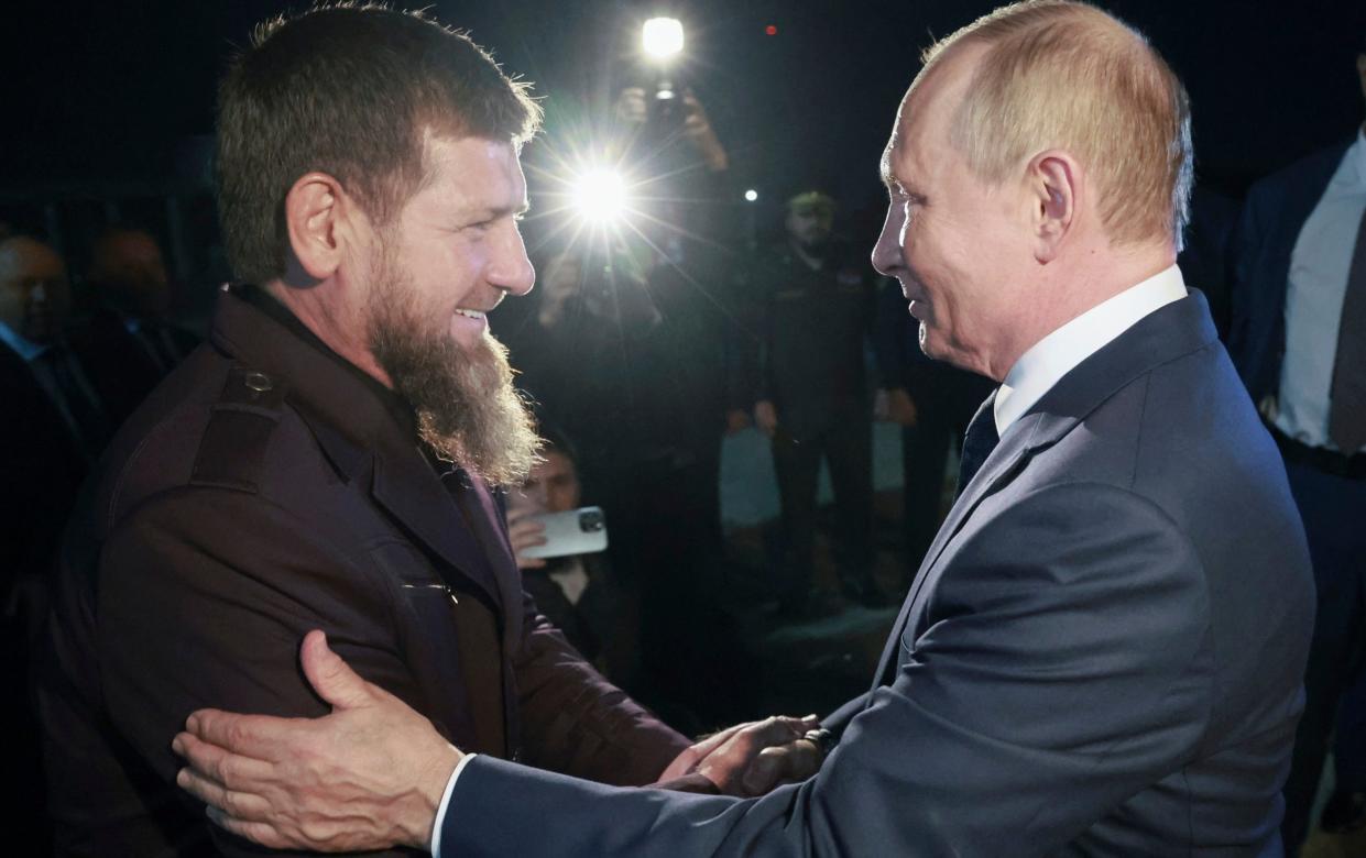 Ramzan Kadyrov, the Chechen leader welcomes Vladimir Putin, the Russian president, on his arrival at Grozny airport