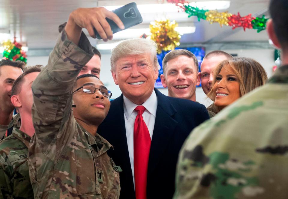 US President Donald Trump and First Lady Melania Trump greet members of the US military during an unannounced trip to Al Asad Air Base in Iraq on December 26, 2018. (Photo by SAUL LOEB / AFP)SAUL LOEB/AFP/Getty Images ORIG FILE ID: AFP_1BU3JB