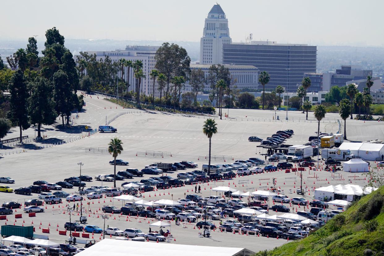 Motorists line up at a COVID-19 vaccination site at Dodger Stadium on Tuesday, Feb. 23, 2021, in Los Angeles, Calif.