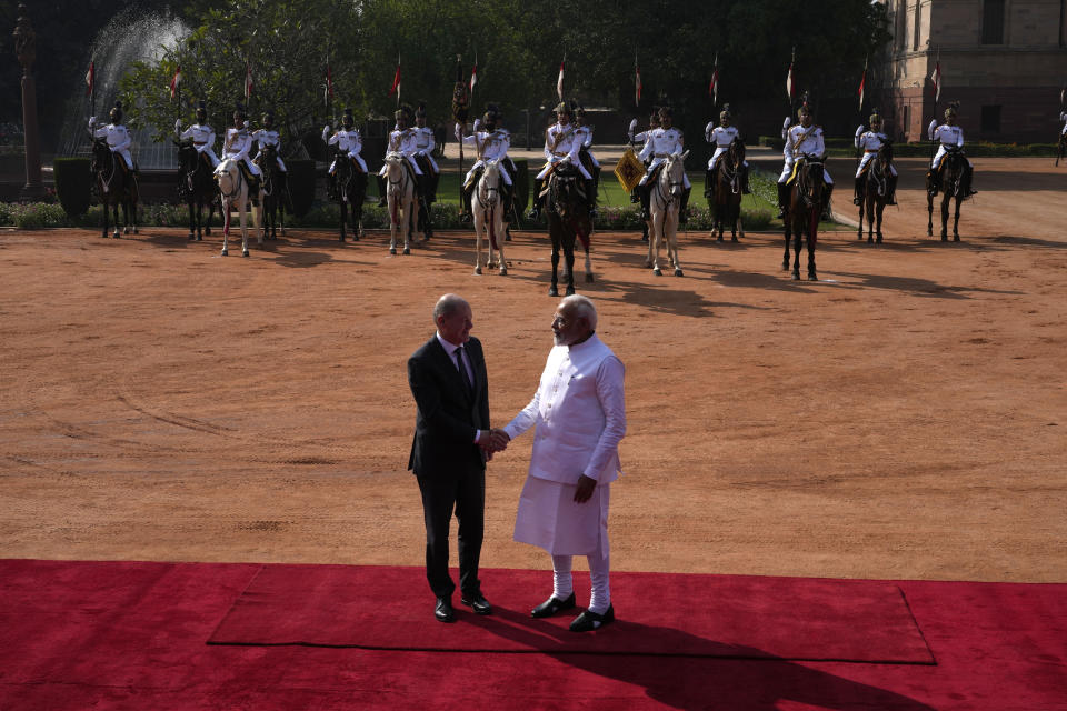 Indian Prime Minister Narendra Modi, right, shakes hand with German Chancellor Olaf Scholz, during latter's ceremonial reception at the Indian presidential palace in New Delhi, India, Saturday, Feb. 25, 2023. (AP Photo/Manish Swarup)