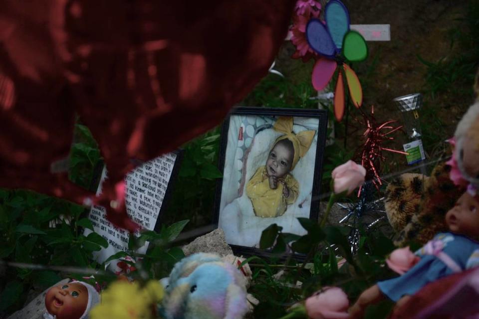A memorial sits near the woods where 6-month-old Kha’liya Bridgewater was found dead in May in east Kansas City.