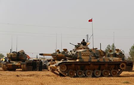 Turkish army tanks and military personal are stationed in Karkamis on the Turkish-Syrian border in the southeastern Gaziantep province, Turkey, August 25, 2016. REUTERS/Umit Bektas