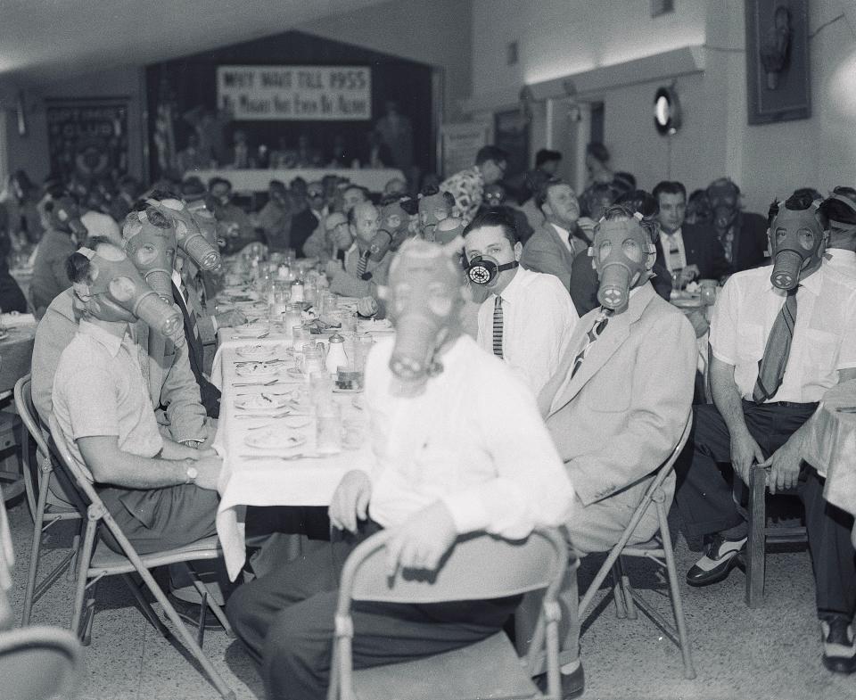 Highland Park Optimist Club wearing smog-gas masks at banquet c. 1954, in the Highland Park district, Los Angeles.