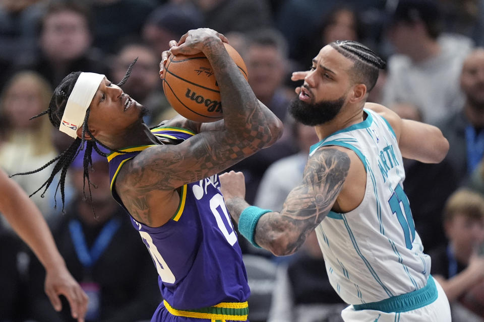 Charlotte Hornets forward Cody Martin (11) defends against Utah Jazz guard Jordan Clarkson (00) during the second half of an NBA basketball game Thursday, Feb. 22, 2024, in Salt Lake City. (AP Photo/Rick Bowmer)