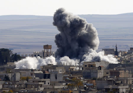 An explosion following an air strike is seen in western Kobani neighbourhood, November 23, 2014. REUTERS/Osman Orsal