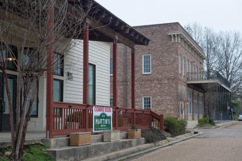 A sign announcing that Martin's, now in downtown Jackson, will be opening a location at Livingston hangs on the porch railing of the former site of 'The Gathering' restaurant on Thursday, March 6. Changes at Livingston, including the sale of some buildings, bring uncertainty to the area called on its website, a 'new town with an old soul.'