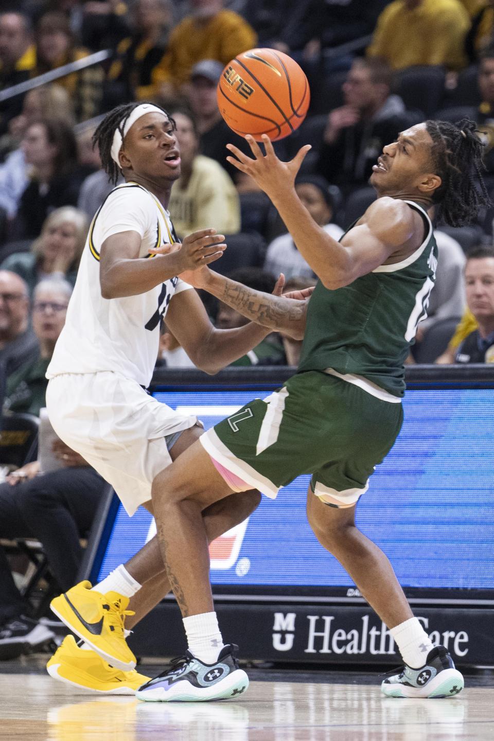 Loyola Md's D'Angelo Stines, right, and Missouri's Anthony Robinson II, left, battle for a loose ball during the second half of an NCAA college basketball game Saturday, Nov. 25, 2023, in Columbia, Mo. Missouri won 78-70. (AP Photo/L.G. Patterson)