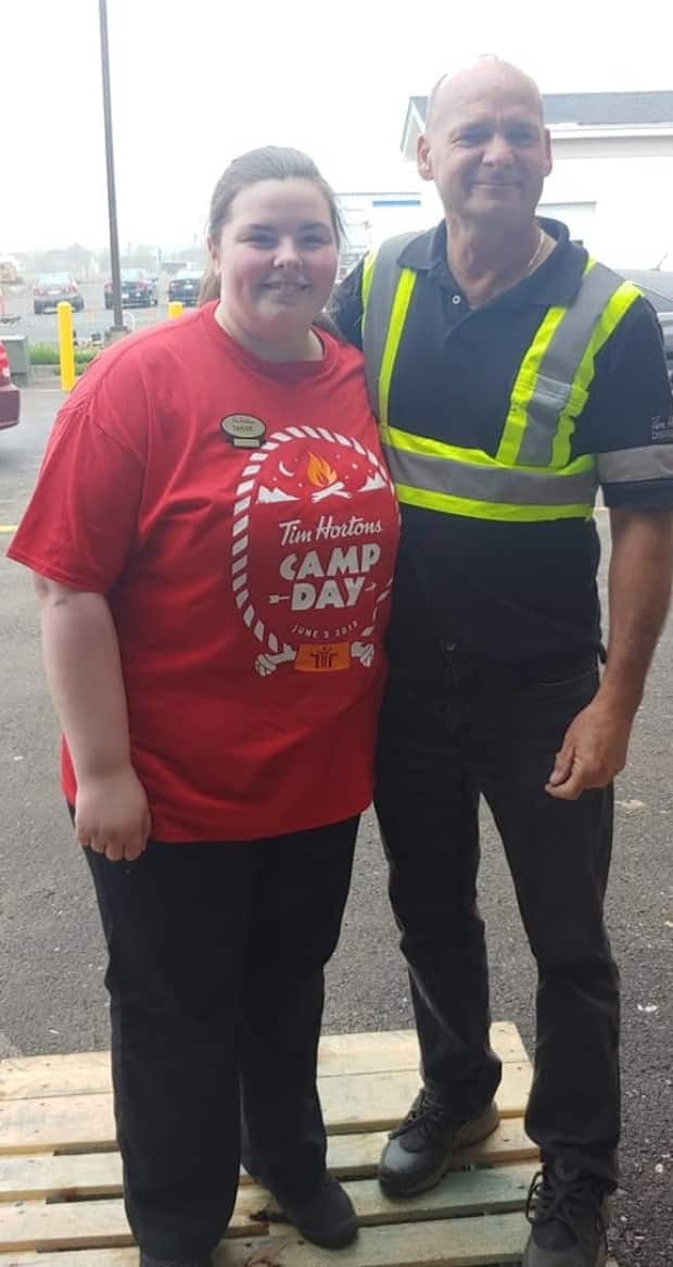 Taylor Levesque with Glenn Fisher at the Tim Hortons outlet they worked at.