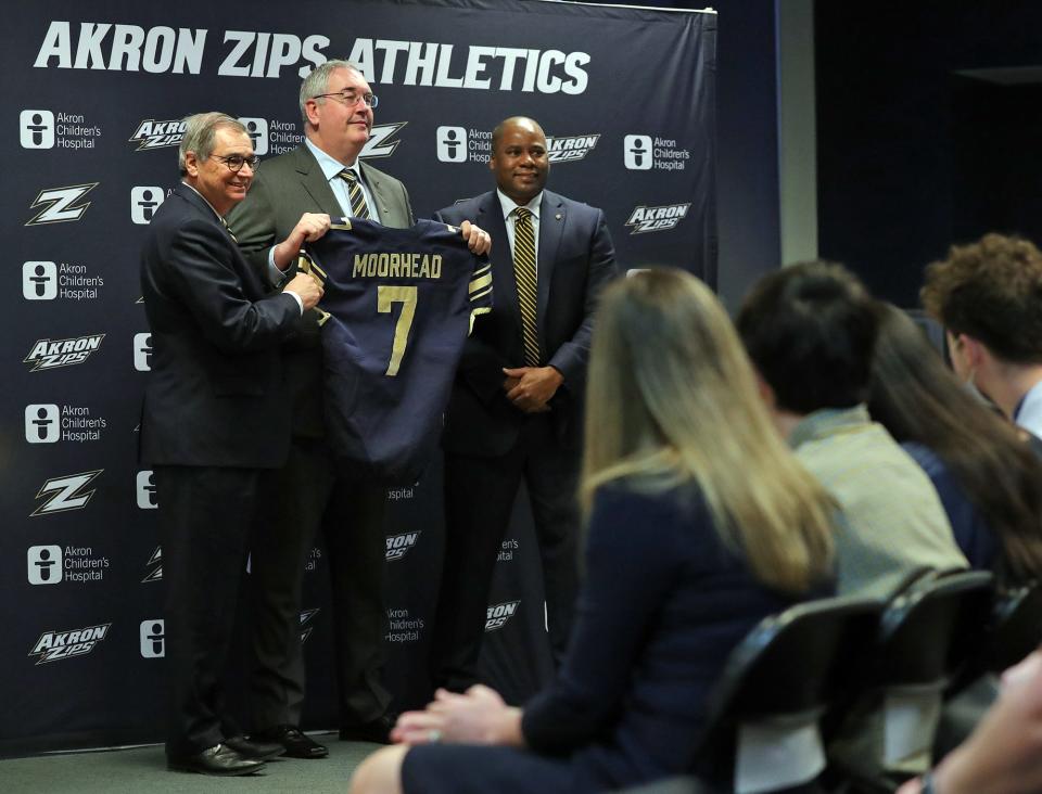 Joe Moorhead, the new new head coach of the Akron Zips football team, poses for a photo with the University of Akron President Gary Miller, left, and Director of Athletics Charles Guthrie, right, during a press conference at InfoCision Stadium on Thursday.