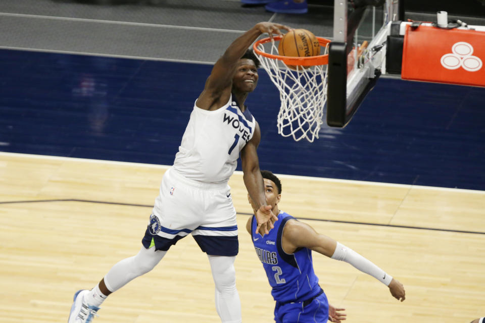 Minnesota Timberwolves forward Anthony Edwards (1) dunks in front of Dallas Mavericks guard Tyler Bey (2) in the fourth quarter of an NBA basketball game, Sunday, May 16, 2021, in Minneapolis. The Timberwolves defeated the Mavericks 136-121. (AP Photo/Andy Clayton-King)