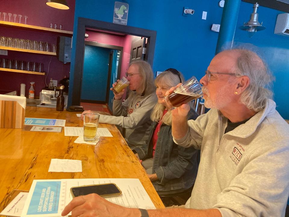 Brian and Deb Roderer of Richmond and Jim Itin (rear) of Stowe drink beer Sept. 14, 2023 at Soulmate Brewing in Morrisville.