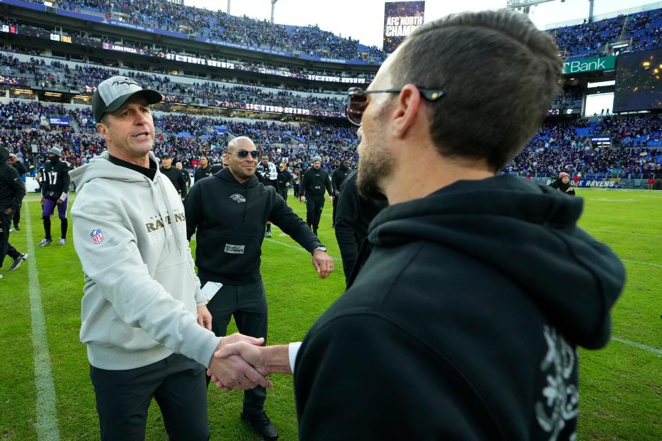 Baltimore Ravens head coach John Harbaugh, left, shakes hands with Miami Dolphins head coach Mike McDaniel, right, after an NFL football game in Baltimore, Sunday, Dec. 31, 2023. (AP Photo/Matt Rourke)
