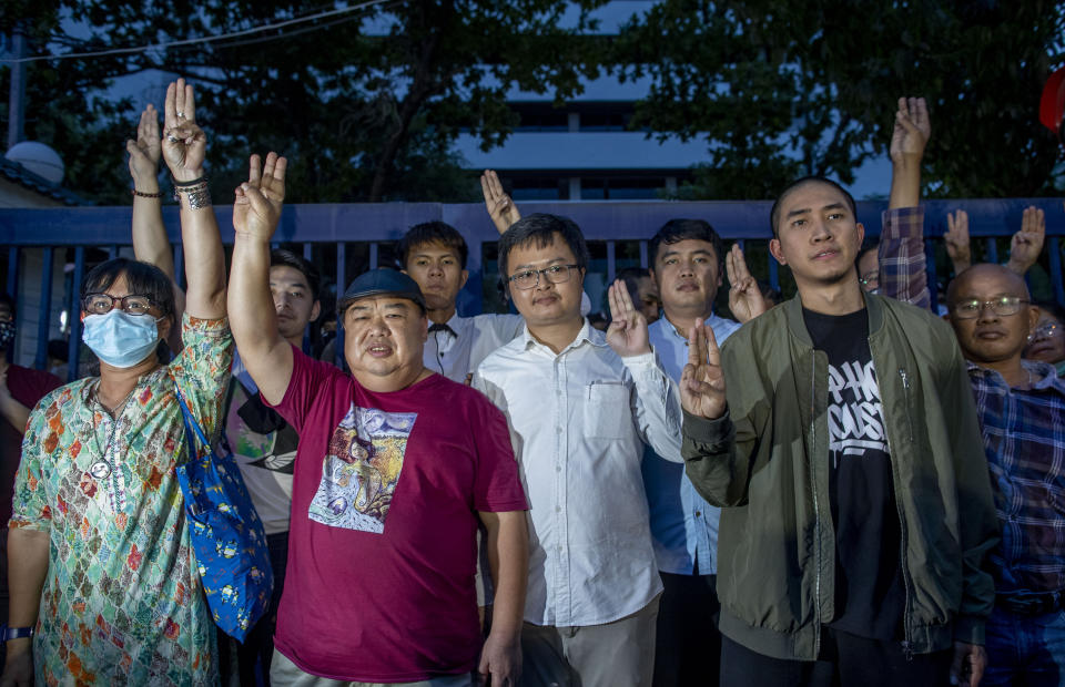 Pro-democracy activists from left Suwanna Tanlek, Nuthawut Somboonsap, Baramee Chairat, Thanayuth Na Ayuthaya, Arnon Nampha, Korakot Saengyenpan, Dechathorn Bamrungmuang and Thanee Sasom raise a three-fingers, symbol of resistance salute outside the criminal courthouse in Bangkok, Thailand, Thursday, Aug. 20, 2020. Thai police arrested nine pro-democracy activists, including two rappers, in a crackdown on growing protests that have emerged as the most serious threat to the government led by a former army general they accuse of incompetence and corruption. Thai criminal court released all nine of them on bail. (AP Photo/Gemunu Amarasinghe)