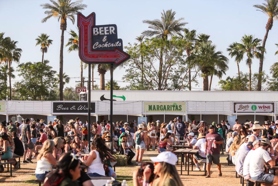 Festivalgoers get drinks and food in one of the concessions areas during the Stagecoach country music festival in Indio, Calif., Friday, April 29, 2022.