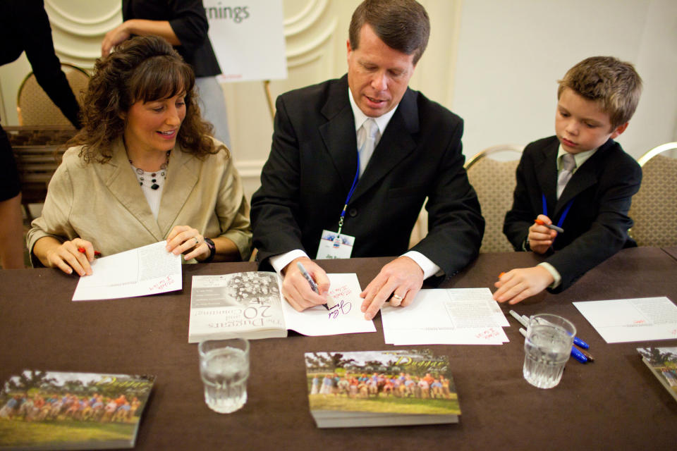 WASHINGTON - SEPTEMBER 17: Michelle Duggar and Jim Bob Duggar, stars of The Learning Channel TV show '19 Kids and Counting,' pose for a picture with a fan while signing copies of their book at the Values Voter Summit on September 17, 2010 in Washington, DC. The annual summit drew nearly two thousand people to advocate for conservative causes. (Photo by Brendan Hoffman/Getty Images)