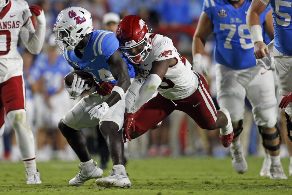 Oct 7, 2023; Oxford, Mississippi, USA; Mississippi Rebels running back Ulysses Bentley IV (24) runs the ball as Arkansas Razorbacks linebacker Jaheim Thomas (28) makes the tackle during the first half at Vaught-Hemingway Stadium. Mandatory Credit: Petre Thomas-USA TODAY Sports