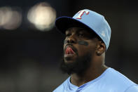 Texas Rangers outfielder Adolis García makes a face as he heads back to the dugout in the eighth inning of a baseball game against the Houston Astros Sunday, April 7, 2024, in Arlington, Texas. (AP Photo/Richard W. Rodriguez)