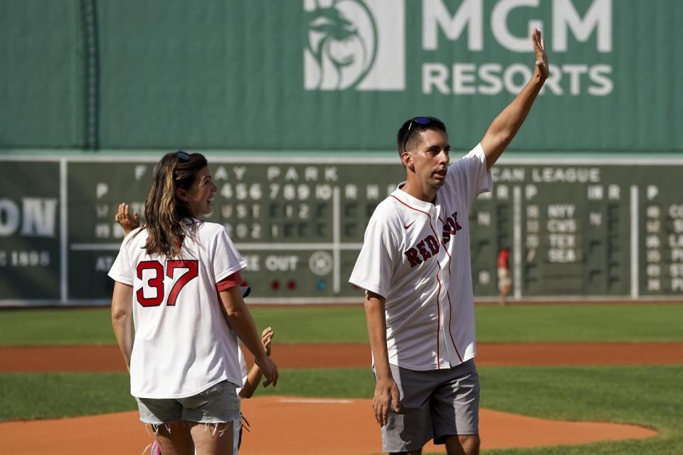 Chris Snow waves from the infield at Fenway Park