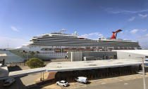 The Carnival Cruise ship "Liberty" is docked at Port Canaveral, Fla., as crew members get vaccinated for COVID-19, Wednesday, May 12, 2021. The crew received the Johnson & Johnson vaccine from a team of nurses staffed from Parrish Medical Center in Titusville. More crews from other ships are scheduled to receive the vaccinations in coming days, including a Royal Caribbean crew next week. (Joe Burbank/Orlando Sentinel via AP)