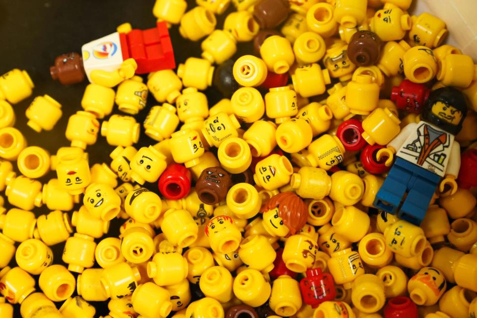 A close-up showing Lego heads and two mini-figurines