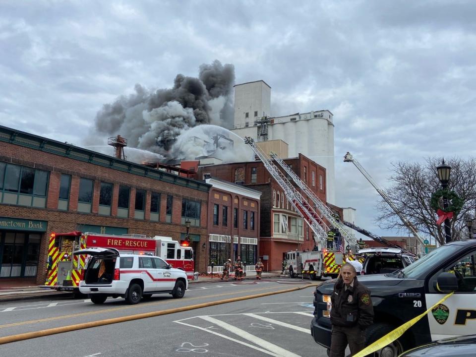 Firefighters battle a blaze Friday morning on North Water Street in downtown Kent.