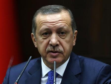 Turkey's Prime Minister Tayyip Erdogan addresses members of parliament from his ruling AK Party (AKP) during a meeting at the Turkish parliament in Ankara January 28, 2014. REUTERS/Umit Bektas