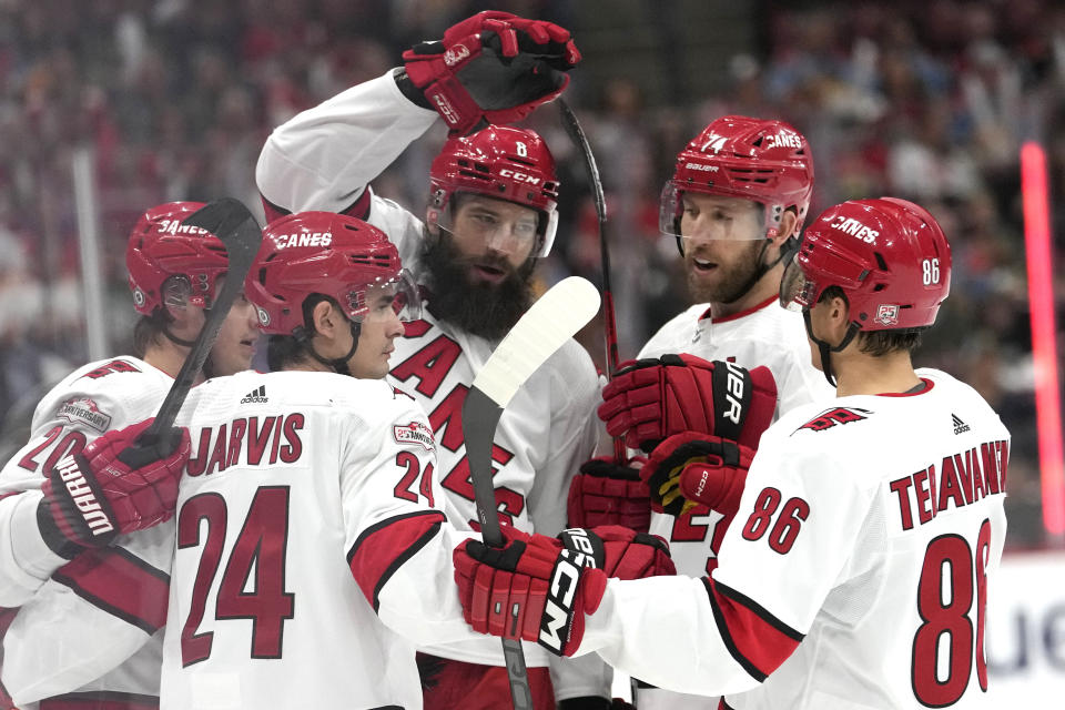 Carolina Hurricanes defenseman Brent Burns, center, celebrates after scoring a goal during the first period of an NHL hockey game against the Florida Panthers, Thursday, April 13, 2023, in Sunrise, Fla. (AP Photo/Lynne Sladky)