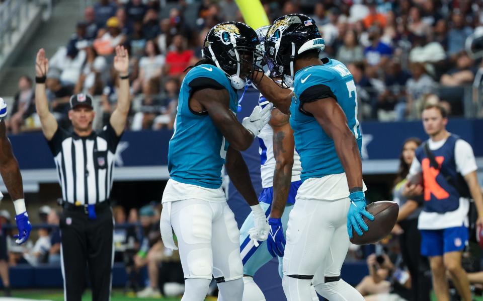 Aug 12, 2023; Arlington, Texas, USA; Jacksonville Jaguars wide receiver Zay Jones (7) celebrates with Jacksonville Jaguars wide receiver Calvin Ridley (0) after making a touchdown catch during the first quarter against the Dallas Cowboys at AT&T Stadium. Mandatory Credit: Kevin Jairaj-USA TODAY Sports
