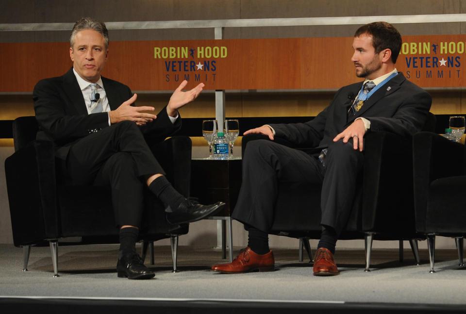 NEW YORK, NY - MAY 07:  Jon Stewart and Salvatore Giunta, Medal of honor Recipient speak at the Robin Hood Veterans Summit at Intrepid Sea-Air-Space Museum on May 7, 2012 in New York City.  (Photo by Craig Barritt/Getty Images for The Robin Hood Foundation)