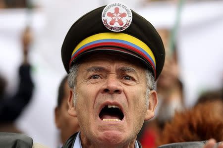 A demonstrator takes part in a march in support of peace talks in Bogota November 19, 2014. REUTERS/John Vizcaino