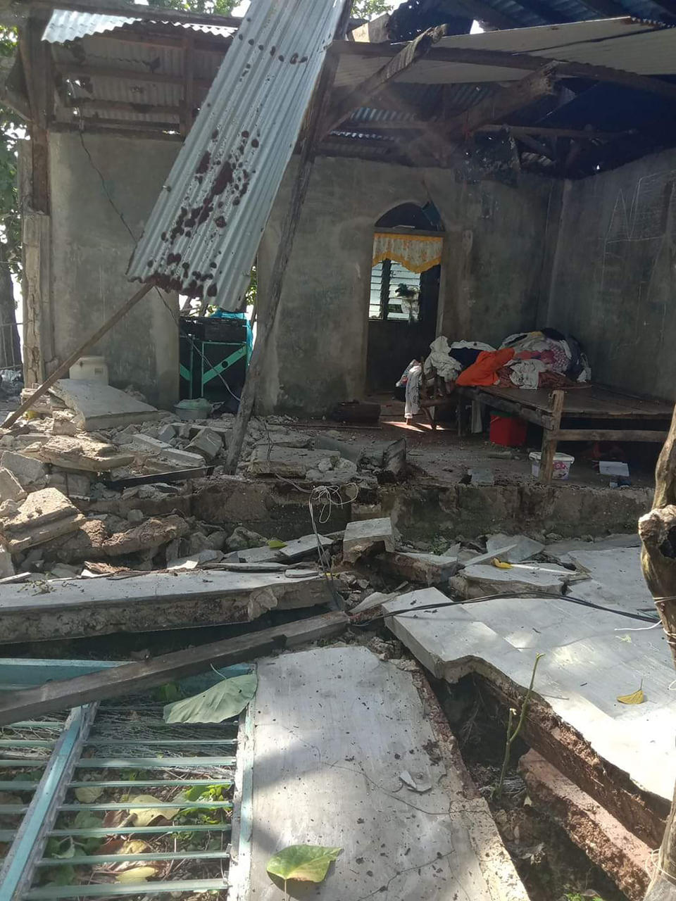 In this photo provided by the Philippine Red Cross, debris are scattered at a house after a magnitude quake struck in Cataingan, Masbate province, central Philippines on Tuesday Aug. 18, 2020. A powerful and shallow earthquake struck a central Philippine region Tuesday, prompting people to dash out of homes and offices but there were no immediate reports of injuries or major damage. (John Mark Lalaguna/Philippine National Red Cross via AP)