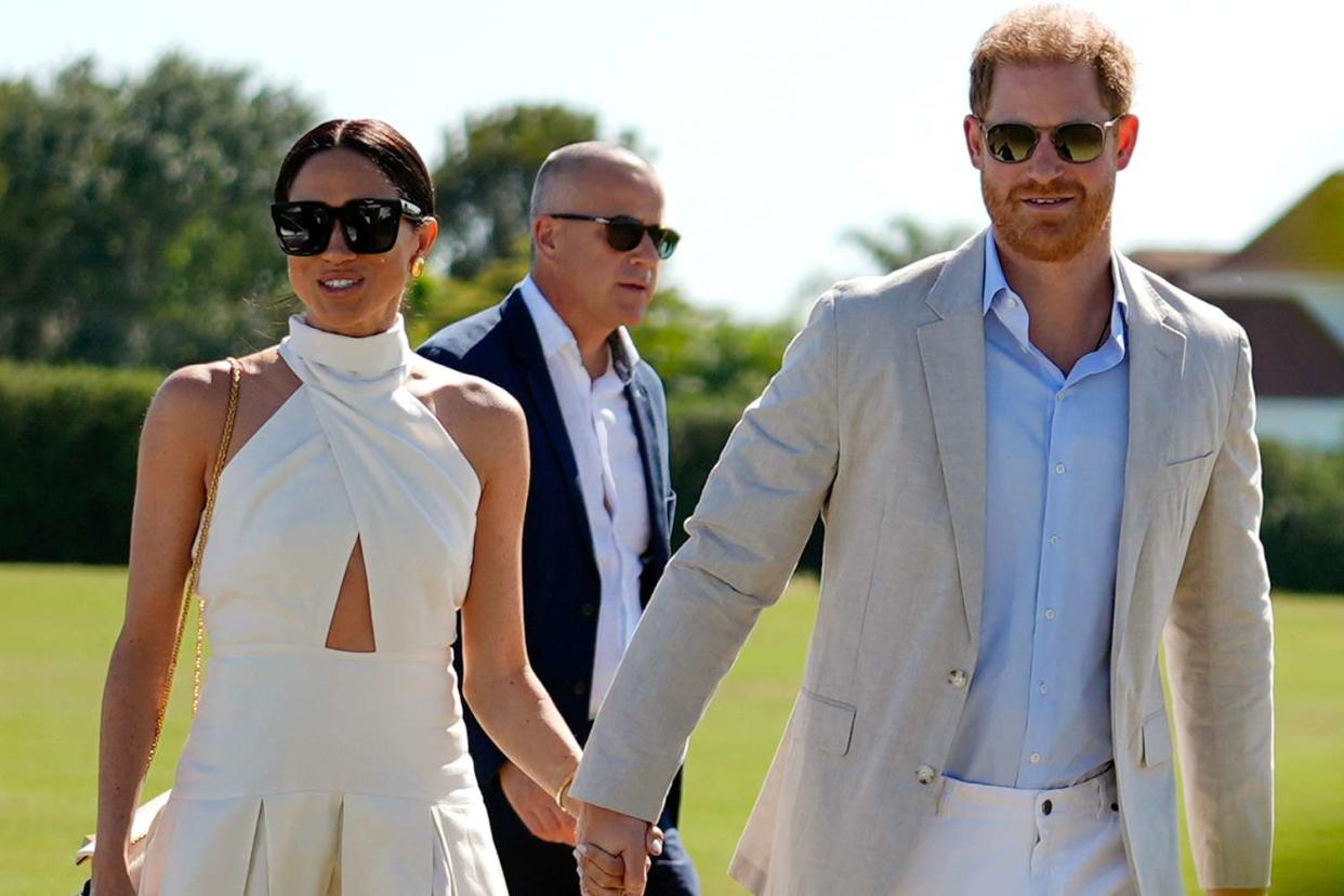 <p>Rebecca Blackwell/AP</p> Meghan Markle (left) and Prince Harry attend the Royal Salute Polo Challenge in Florida on April 12, 2024