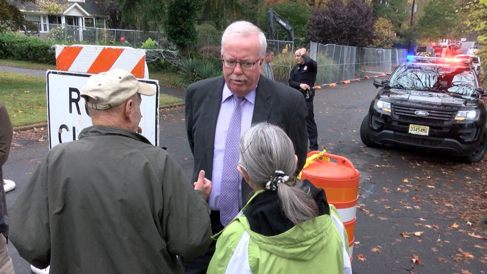 Woodbridge Mayor John McCormac speaks Wednesday, October 30, 2019, with residents near the scene where a plane crashed into home on Berkeley Avenue in Colonia.