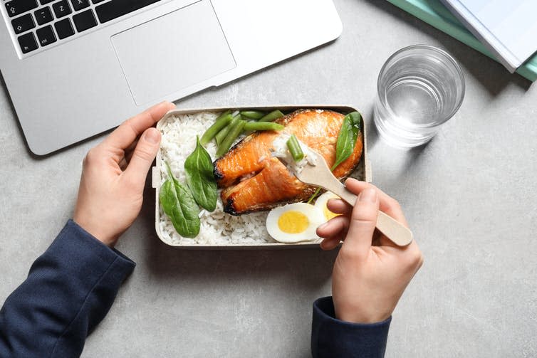 A lunch of salmon, a boiled egg, and edamame.