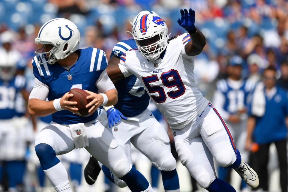 Buffalo Bills defensive end Kingsley Jonathan (59) applies pressure to Indianapolis Colts quarterback Sam Ehlinger during the second half of an NFL preseason football game in Orchard Park, N.Y., Saturday, Aug. 12, 2023.