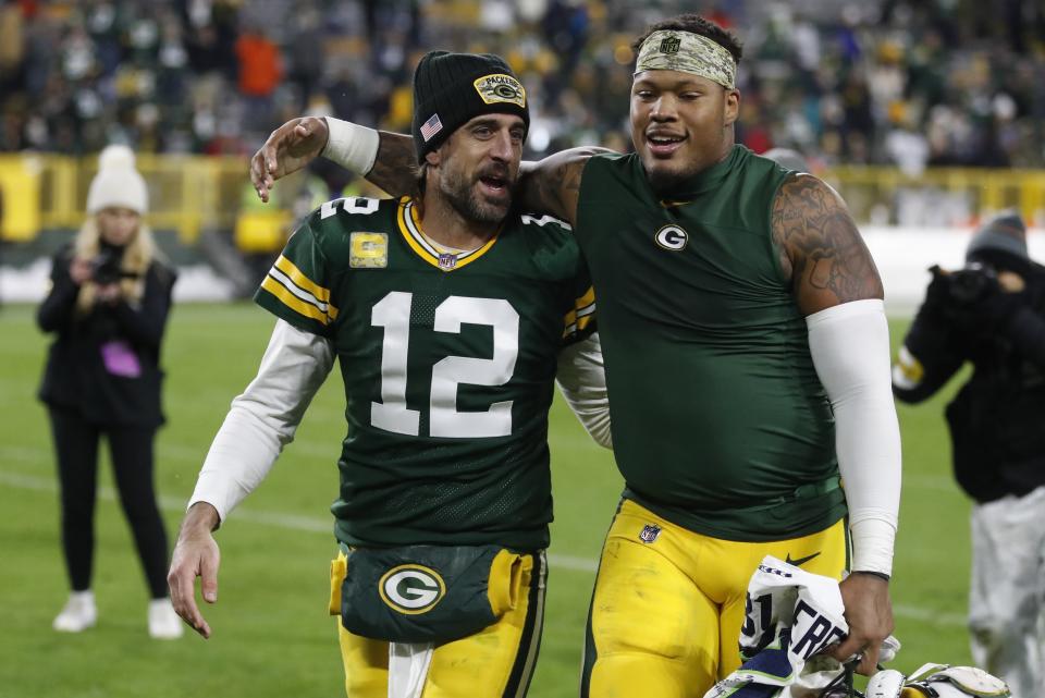 Green Bay Packers' Aaron Rodgers and Preston Smith walk off the field after an NFL football game against the Seattle Seahawks Sunday, Nov. 14, 2021, in Green Bay, Wis. The Packers won 17-0. (AP Photo/Matt Ludtke)