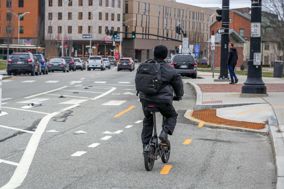 A cyclist travels along one of the bike lanes on South Water Street in Providence.