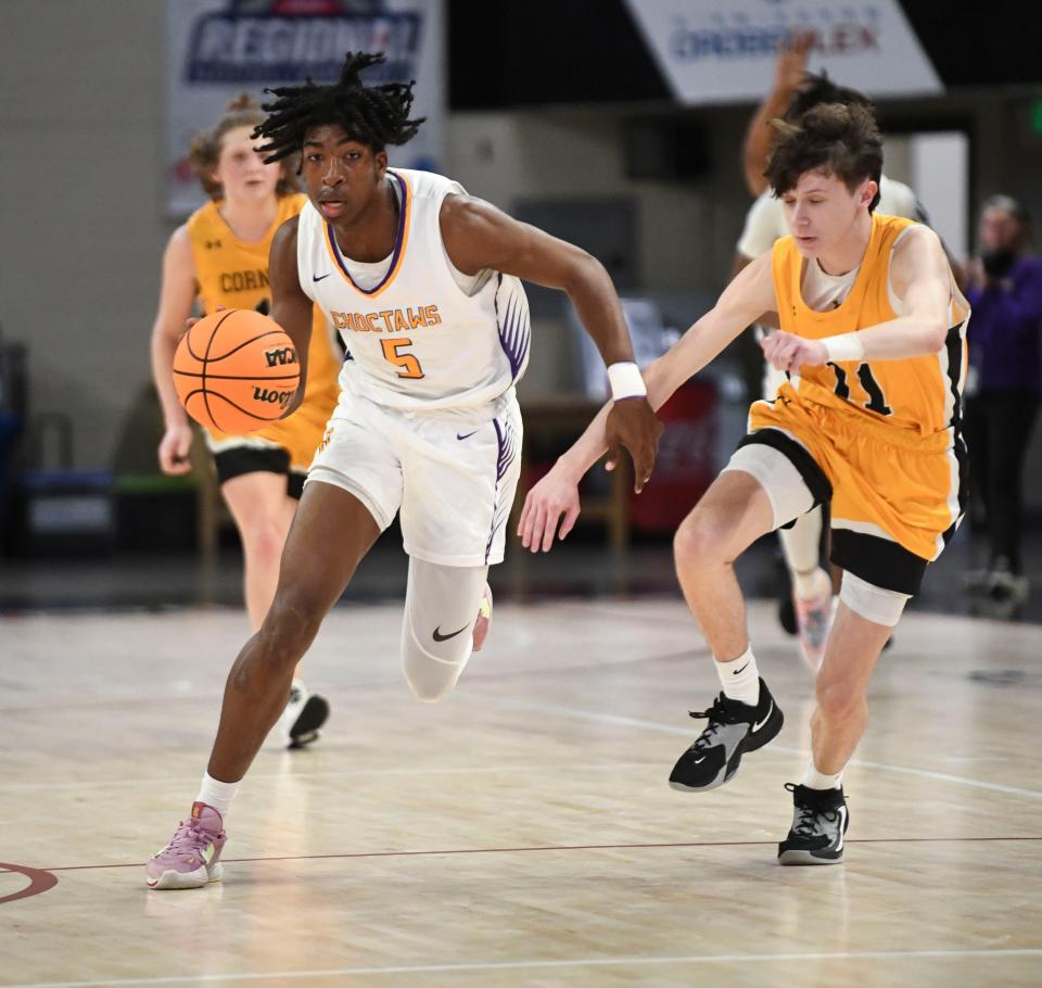 Feb 21, 2023; Birmingham, Alabama, USA; Central High's King Larkin (5) brings the ball up against Corner guard Will McMichens (11) at Bill Harris Arena during the 4A Boys Central Regional Semifinal. 