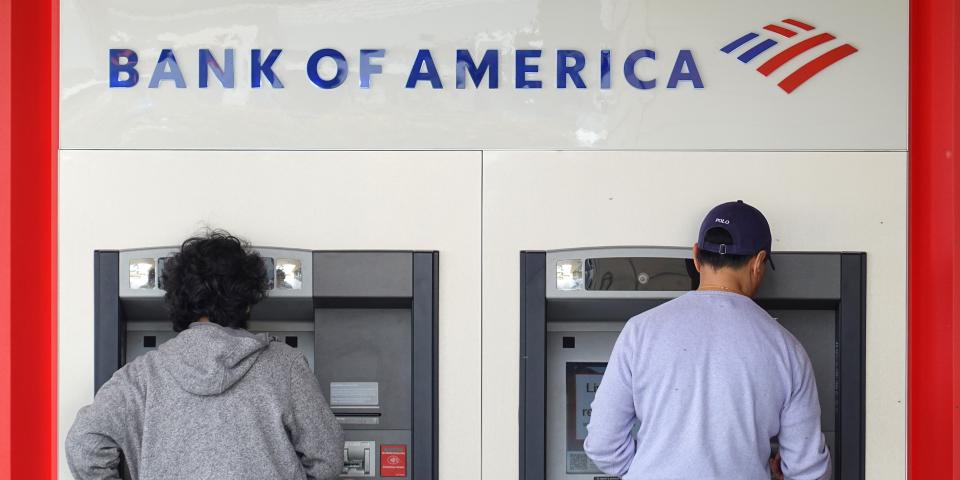 Customers use an ATM at a Bank of America