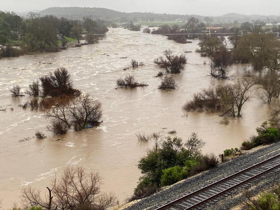 The Salinas River was wide and muddy as it flowed just south of the Niblick Road Bridge on Jan. 9, 2023 as another atmospheric river storm hit the coast. Paso Robles ordered evacuations on multiple streets along the east side of the river as water levels rose.