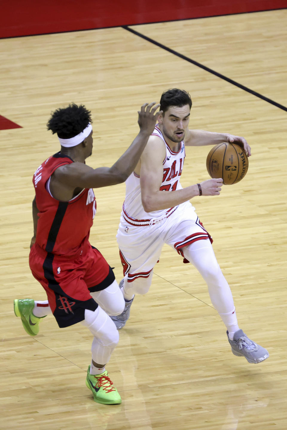 Chicago Bulls' Tomas Satoransky, right, drives past Houston Rockets' Danuel House Jr., left, during the third quarter of an NBA basketball game Monday, Feb. 22, 2021, in Houston. (Carmen Mandato/Pool Photo via AP)