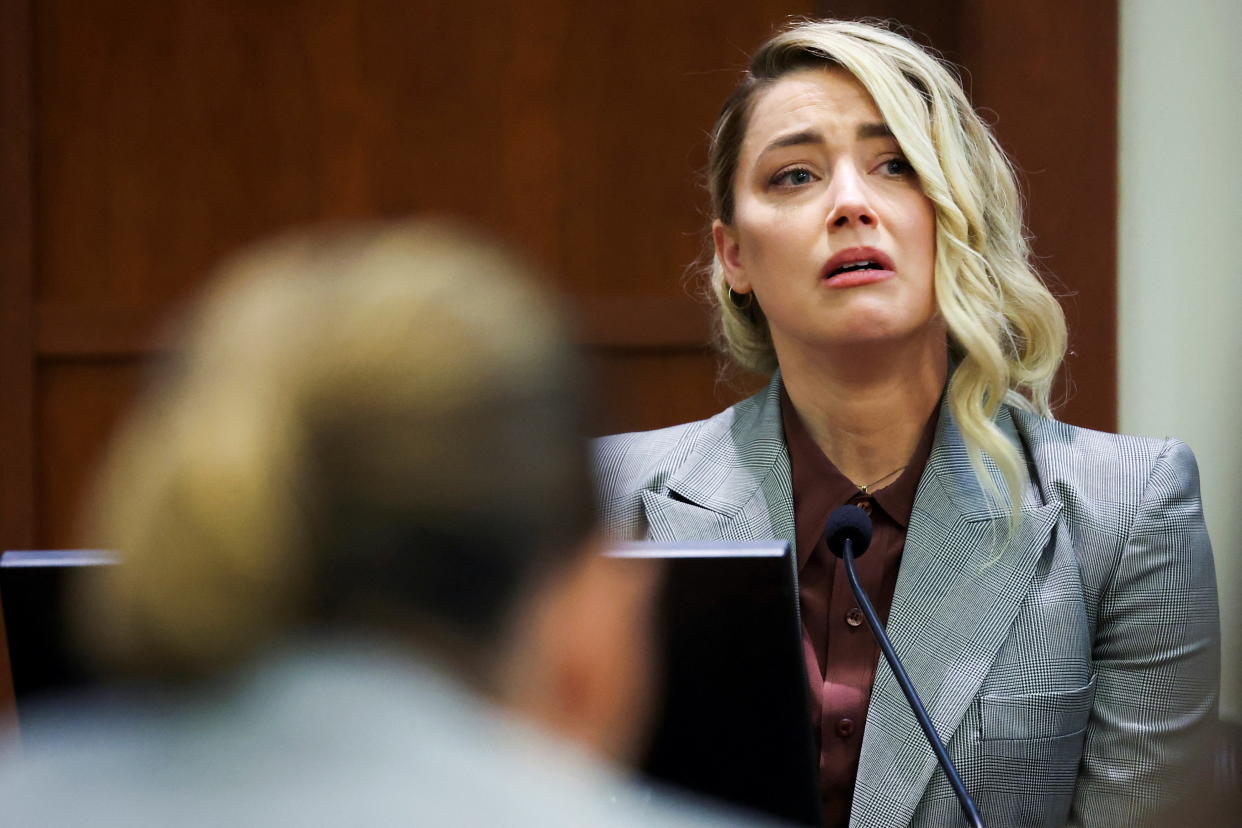 Actor Amber Heard testifies near Actor Johnny Depp during the Depp vs Heard defamation trial at the Fairfax County Circuit Court in Fairfax, Virginia, U.S. May 26, 2022. Michael Reynolds/Pool via REUTERS