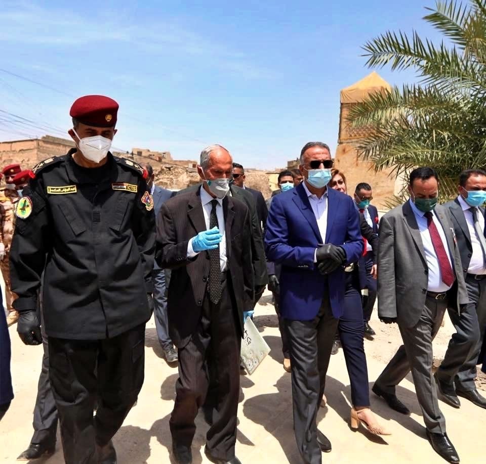 TAKES OUT REFERENCE TO DESIGNATE - Iraqi Prime Minister Mustafa al-Kahdimi, center, visits the site of the Al–Nuri mosque, which was destroyed by Islamic State militants, during his visit to Mosul, Iraq, Wednesday, June 10, 2020. (Iraqi Prime Minister Media Office, via AP)