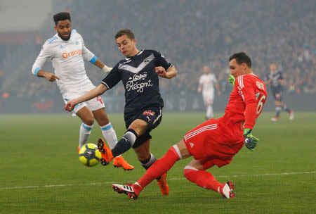 Soccer Football - Ligue 1 - Olympique de Marseille vs Bordeaux - Orange Velodrome, Marseille, France - February 18, 2018 Marseille's Yohann Pele clears from Bordeaux's Nicolas De Preville REUTERS/Jean-Paul Pelissier