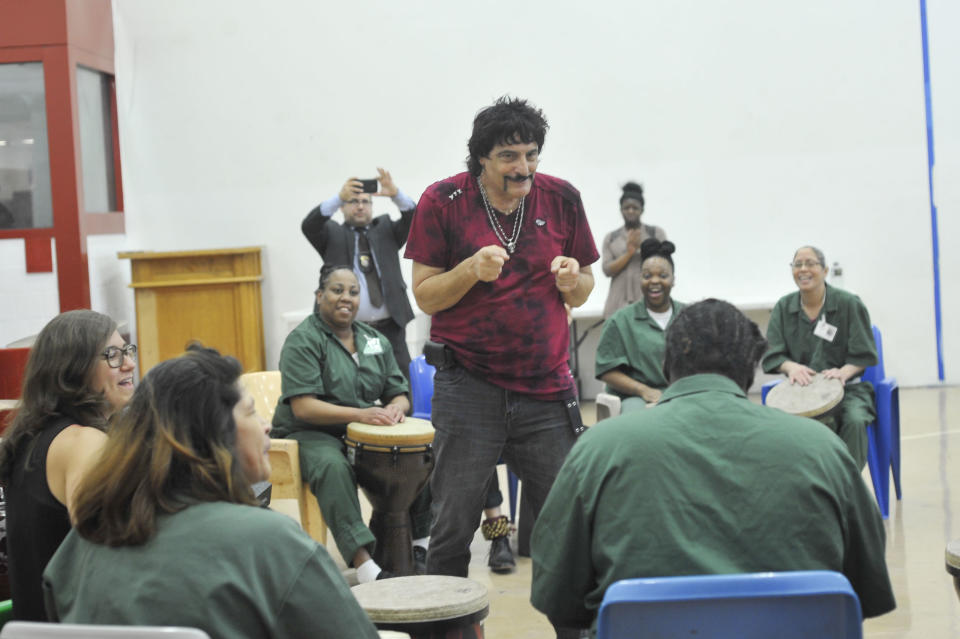 Carmine Appice leads inmates in a drum circle, encouraging them to take on solos.