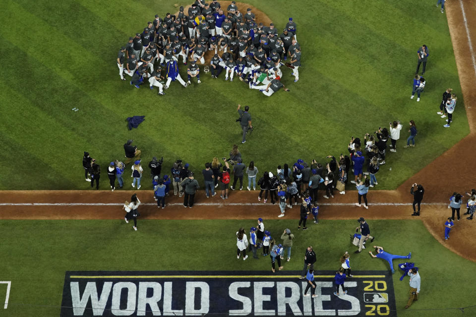 Los Angeles Dodgers pose for a group photo after defeating the Tampa Bay Rays 3-1 to win the baseball World Series in Game 6 Tuesday, Oct. 27, 2020, in Arlington, Texas. (AP Photo/David J. Phillip)