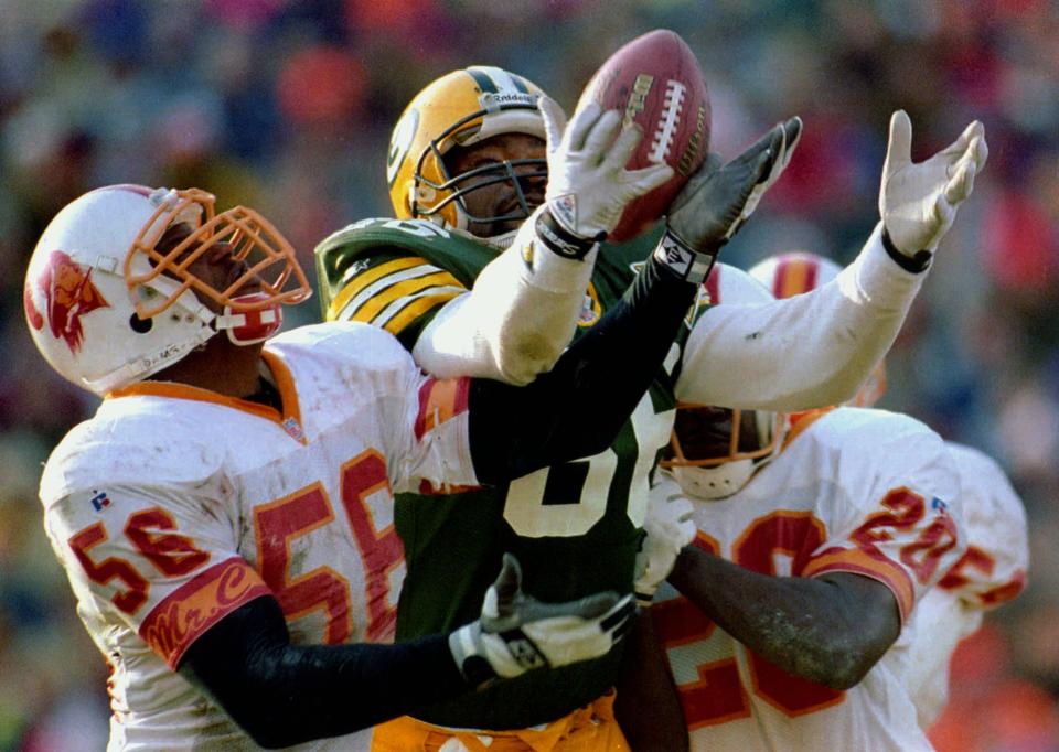 Green Bay Packers tight end Ed West reaches for a deflected pass against the Tampa Bay Buccaneers in 1993.