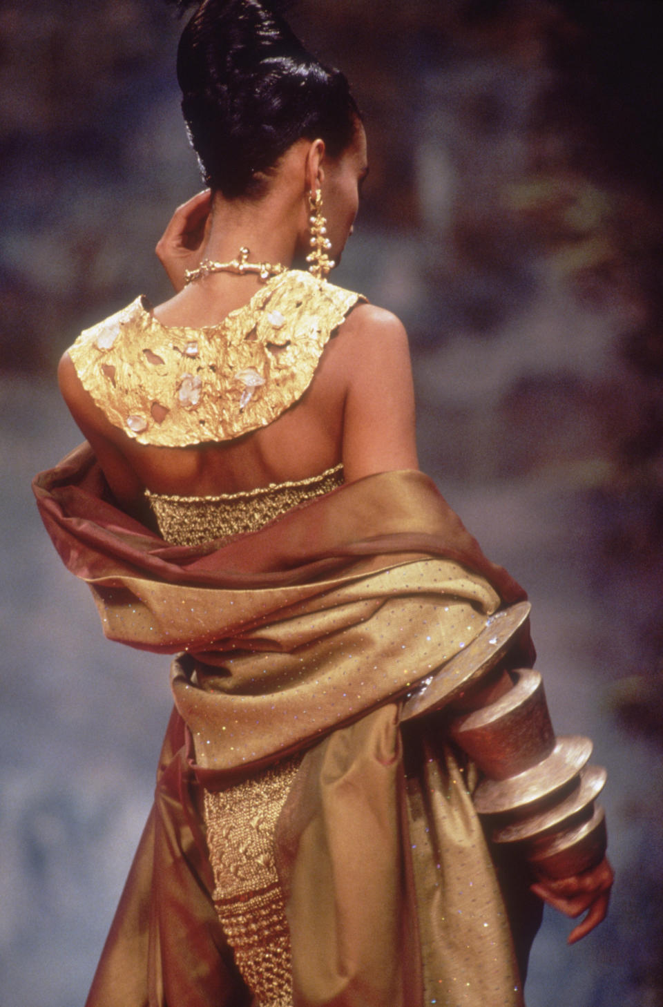 A model wears a gold design from the designer's spring/summer 1991 couture collection.