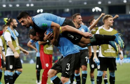 Soccer Football - World Cup - Round of 16 - Uruguay vs Portugal - Fisht Stadium, Sochi, Russia - June 30, 2018 Uruguay's Diego Godin and Luis Suarez celebrate after the match. REUTERS/Murad Sezer