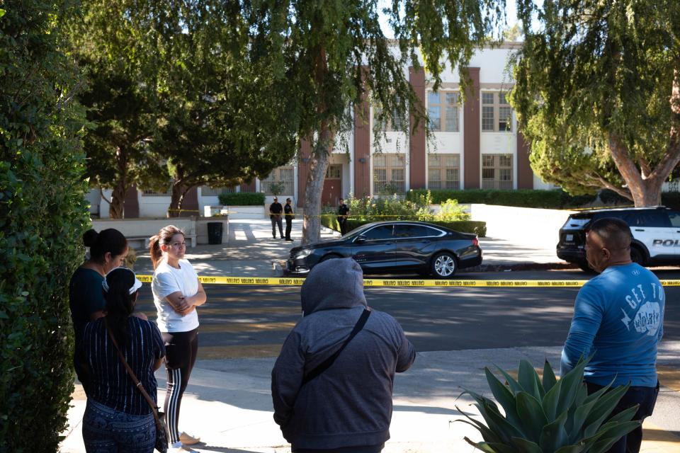 Parents wait outside of Van Nuys High School after a brawl and stabbing occurred Wednesday at the school near Los Angeles. Two students were stabbed and two others were injured, while three others were detained for questioning.